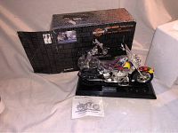 Overall view of the Harley-Davidson motorcycle styled pushbutton telephone with original box and instruction manual visible.