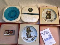 Three boxed collector plates including two Hummel Merry Christmas plates and one President Monroe limited edition plate, all in original packaging.