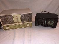 Showing the full front and top of the two radio alarm clocks; cream Zenith with crack on top and black Emerson unit