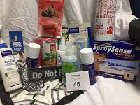 Photo showing assorted dog supplies including spray collar, muzzle, toothbrush, ear cleaner, control collar, supplements, and leashes.