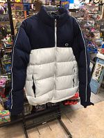 Front and angled views of a Nike men's puffer jacket size Medium showing zip front, collar, color blocking, and Nike logo on chest.