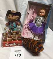 Photo showing the vintage Madame Alexander doll in box, troll doll, Orange Crush bottles in cardboard carrier, and plush hedgehog toy arranged with auction lot number card.