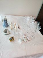 Photo of entire collection including cut crystal stemware, ceramic angels, ceramic baskets, matchbox holders, ceramic candles, and candy dish.