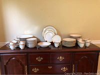 Full set of 60 pieces laid out on wooden cabinet, showing all item types.
