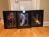 Set of three prints in wooden frames showing Jerry Garcia, Stevie Ray Vaughan, and Jimi Hendrix.
