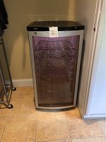 Front view of Haier wine refrigerator with glass door and rack storage, showing the digital control panel and key lock.