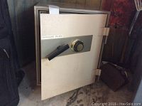 Full view of the Vanguard VS-200 safe with door slightly open, showing the handle and combination dial.