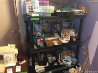 Shelving unit with various crafting supplies including kits, boxes, and model planes