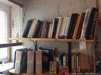 Shelf of assorted books on health, diet, herbs, self help, and more, showing a variety of titles and colorful binding.