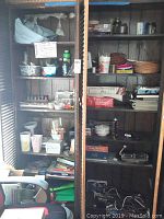 Overview of two wooden cabinets filled with various craft supplies, board games, magazines, and miscellaneous items.