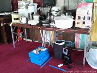 Photo showing both tables setup with various household items placed on them.