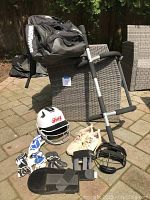 Photo showing the full set of softball training equipment including helmet, gloves, bag, face guard, sliding mitt, and cleats.