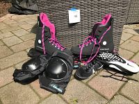 Photo showing the pair of black and pink roller blades, protective black knee pads, and brand new black and white Nike sprinting sneakers.