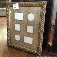 Gold ornate picture frame with six photo openings on a patterned beige matte insert.