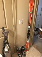 Full view of the skis with Marker bindings and Lange boots showing size and condition.