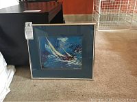 Full view of framed print against carpeted floor showing overall condition and matting color