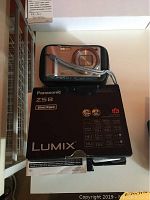 Panasonic Lumix ZS8 box with the camera on top showing brand and model information
