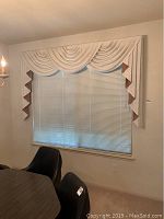 Mini blinds and valance set on 72x60 window with swag and zigzag patterned fabric valance in off-white color.