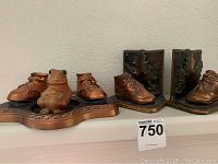 Overall lot showing bronze baby shoe bookends and decorative myrtlewood frog piece on base