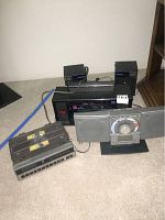 Photo showing the variety of stereos and speakers including Bose system and stereo receiver with speakers on carpeted floor.