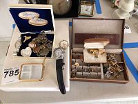 Overview of lot showing two jewelry boxes, a plastic divided tray, and assortment of watches, pendants, chains, and cufflinks