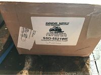 Closed cardboard box with SS Diesel Supply label showing model SSD5521WE and serial number J277635, indicating a remanufactured pump.