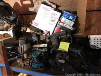 Photo showing multiple sanders including Craftsman belt sander, Makita orbital sander, and sanding accessories like sanding discs and hook & loop sandpaper boxes