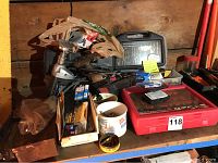 Photo showing various drill attachments including wire wheel brushes, cup brushes, and drill cases on shelf