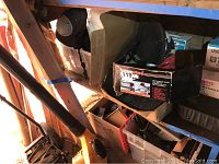 Yellow wheeled drywall panel hoist and orange jobsite dryer visible under shelving