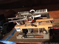 Full view of Black & Decker WorkMate bench top work center with mounted adjustable angle guide and clamps.