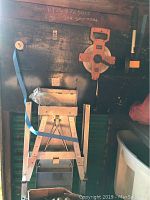 Photo showing aluminum drywall stand with blue strap, measuring approximately 42x16x18 inches.