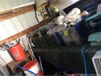 General overview of crates containing buckets, green tarp and assorted packaged items