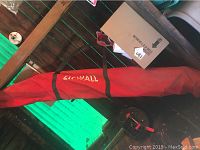 Red Zipwall carrying bag containing poles, laid flat.