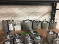 Seven Swarovski crystal figurines displayed on original round gray and white boxes against a wall