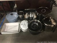 Overview of all items showing cookware grouped including stainless pot, strainers, ceramic clad ironware, and baking dishes.