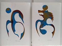 Front view of two Indigenous prints showing abstract shapes in blue and brown colors on white paper.