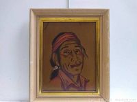 Full front view of the framed Indigenous art portrait featuring a native individual with reddish headband and earring, captured in warm earth tones.