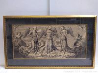 Framed black and white antique print depicting angels with radiant background, rectangular frame with gold edge.