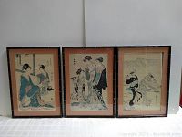 Three framed Japanese vintage prints showing traditional scenes, two with women in kimonos and one with a turtle and person by mountains.