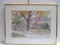 Full view of watercolor print framed, showing a residential house and large tree in fall colors.