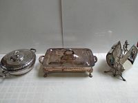Lot of three vintage silverplate items arranged side by side against a white background.
