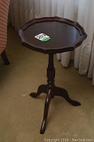Full view of the octagonal small table showing the shape, pedestal and three legs.