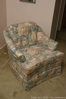 Front-facing image of the custom Morette's upholstered chair showing floral fabric and shape.