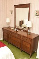 Full view of Gibbard dresser with attached large matching mirror in bedroom setting showing style and condition.