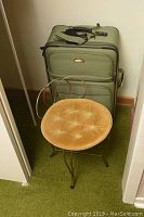27" olive green Ricardo suitcase and velvet seat vanity chair together