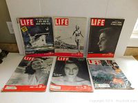 Six vintage LIFE magazines displayed in two rows on a floor, visible front covers with varying subjects from 1940s.