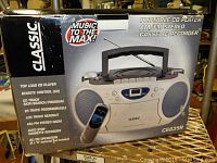 Front view of the Classic CS835R boom box in its original box showing product details and features in English.