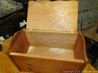 Open top view showing plain interior, wood grain and construction details.