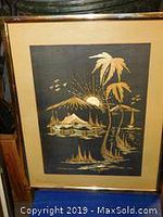 Framed wood art on black silk mat showing detailed mountain and plant landscape.