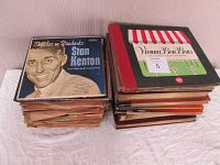 Two stacks of vintage 78 RPM records including 'Sketches on Standards' by Stan Kenton and 'Vienna Bon Bons' showing vintage album covers and graphics.